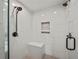 Detailed view of a modern tiled shower with seating, dark hardware, and white tile at 3121 Cox Cemetery Rd, Social Circle, GA 30025