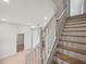 Elegant staircase with wood steps and white railing, offering access to the upper floors of the home at 3121 Cox Cemetery Rd, Social Circle, GA 30025