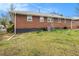 Backyard view of the brick exterior of the home and large lawn area at 965 Laurel St, Morrow, GA 30260