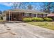 Cozy brick home featuring a covered carport and manicured front yard, perfect for easy access and curb appeal at 965 Laurel St, Morrow, GA 30260