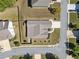 Birds-eye view of a home's roof and driveway in a neighborhood, set on a corner lot with established landscaping and street access at 2190 Leatherstone Dr, Powder Springs, GA 30127