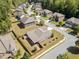 An aerial shot displays a home nestled in a suburban setting, fenced yard, complemented by lush trees and well-maintained streets at 2190 Leatherstone Dr, Powder Springs, GA 30127