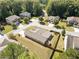 An aerial perspective of a home in a residential area, highlighting its roof, yard, and proximity to neighboring houses and trees at 2190 Leatherstone Dr, Powder Springs, GA 30127