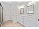 Modern bathroom features a double vanity with framed mirrors and updated fixtures at 2190 Leatherstone Dr, Powder Springs, GA 30127