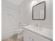 Modern bathroom features a tiled shower/tub and a quartz vanity with framed mirror at 2190 Leatherstone Dr, Powder Springs, GA 30127
