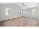 Bright empty bedroom with multiple windows, ceiling fan, and light wood flooring at 2190 Leatherstone Dr, Powder Springs, GA 30127