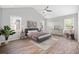 Comfortable bedroom with ceiling fan, multiple windows, and neutral decor at 2190 Leatherstone Dr, Powder Springs, GA 30127