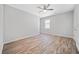 Bright bedroom features hardwood floors, a ceiling fan and a large window at 2190 Leatherstone Dr, Powder Springs, GA 30127