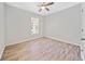 Bright bedroom features hardwood floors, a ceiling fan and a large window at 2190 Leatherstone Dr, Powder Springs, GA 30127