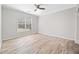 Bright bedroom features hardwood floors, a ceiling fan and a large window at 2190 Leatherstone Dr, Powder Springs, GA 30127