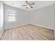 Bright bedroom features hardwood floors, a ceiling fan and a large window at 2190 Leatherstone Dr, Powder Springs, GA 30127