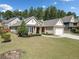 Inviting single-story home with well-maintained landscaping, a stone-accented facade, and a spacious driveway at 2190 Leatherstone Dr, Powder Springs, GA 30127
