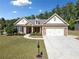 Charming single-story home featuring a stone-accented facade, manicured lawn, and an inviting two-car garage at 2190 Leatherstone Dr, Powder Springs, GA 30127