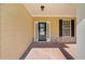Welcoming front porch with stone accents, a black door, and a charming exterior light fixture at 2190 Leatherstone Dr, Powder Springs, GA 30127