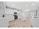 Well-lit kitchen featuring white cabinets, stainless steel appliances, and an island with countertop at 2190 Leatherstone Dr, Powder Springs, GA 30127