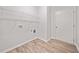 Clean laundry room features hardwood floors and shelving at 2190 Leatherstone Dr, Powder Springs, GA 30127