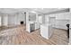 An open layout featuring kitchen with an island, dining, and living room with a fireplace at 2190 Leatherstone Dr, Powder Springs, GA 30127