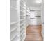 Walk-in closet with white shelving and storage solutions for organizing clothes and accessories at 2190 Leatherstone Dr, Powder Springs, GA 30127