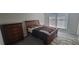 Cozy bedroom featuring a wooden sleigh bed, dresser, and soft, neutral tones at 4252 Parkview Ct, Stone Mountain, GA 30083