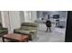 Open-concept living room with modern flooring and a view into the adjacent kitchen at 4252 Parkview Ct, Stone Mountain, GA 30083