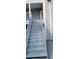 This stairway leads to the upper level of the building with light grey colored steps and railings on both sides at 4252 Parkview Ct, Stone Mountain, GA 30083