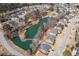 Aerial view of a neighborhood with a scenic pond, a bridge, walking trails, and well-maintained homes at 9122 Golfview Cir, Covington, GA 30014