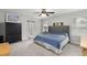 Comfortable bedroom features a tufted headboard, natural light and barn door to ensuite bathroom at 9122 Golfview Cir, Covington, GA 30014