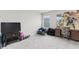 Uncluttered bedroom features a window, carpeted floor, and comic book superhero decorations at 9122 Golfview Cir, Covington, GA 30014