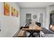 Dining area features a long wood table, bench, chair seating and modern art at 9122 Golfview Cir, Covington, GA 30014