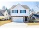 Charming two-story home featuring a brick facade, white siding, and a spacious driveway at 9122 Golfview Cir, Covington, GA 30014