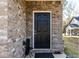 Inviting front entrance with a black door, brick facade, and a welcoming outdoor space, creating curb appeal at 9122 Golfview Cir, Covington, GA 30014