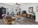 Relaxing living room features sleek wood floors, ample natural light, and a ceiling fan at 9122 Golfview Cir, Covington, GA 30014