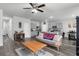 Open-concept living and kitchen area features gray cabinets, wood floors and stainless appliances at 9122 Golfview Cir, Covington, GA 30014