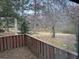 Backyard view of a pond with mature trees from wood railing at 1110 Country Ct, Lawrenceville, GA 30044