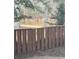 A tranquil backyard view showing a brown fence overlooking a pond surrounded by trees at 1110 Country Ct, Lawrenceville, GA 30044