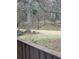 View of serene backyard featuring a tranquil pond, flowering tree, and lush greenery at 1110 Country Ct, Lawrenceville, GA 30044