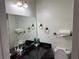 Bathroom featuring a large mirror, black countertop and wall lighting at 1110 Country Ct, Lawrenceville, GA 30044