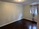 Bright bedroom featuring hardwood floors and a window with decorative curtains at 1110 Country Ct, Lawrenceville, GA 30044