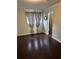 Bedroom featuring dark hardwood floors, natural light, and access to an ensuite bathroom at 1110 Country Ct, Lawrenceville, GA 30044