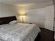 Comfortable bedroom featuring dark wood floors, large closet and warm lighting at 1110 Country Ct, Lawrenceville, GA 30044