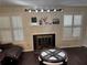 Inviting living room featuring a fireplace, plantation shutters, and stylish decor at 1110 Country Ct, Lawrenceville, GA 30044