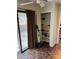 View of a living space with marble floors, sliding glass doors, and a closet with open shelves at 1110 Country Ct, Lawrenceville, GA 30044