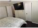 Comfortable bedroom with plush bedding, a television, and two closets for ample storage at 1110 Country Ct, Lawrenceville, GA 30044