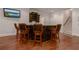 Basement bar with comfortable stools, wooden floors and a TV at 6029 Shadburn Ferry Rd, Buford, GA 30518