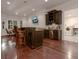 Finished basement with wet bar, leather bar stools, and dark stained cabinets at 6029 Shadburn Ferry Rd, Buford, GA 30518