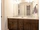 Bright bathroom featuring dual sinks with dark cabinets and an expansive mirror, exuding modern elegance at 6029 Shadburn Ferry Rd, Buford, GA 30518