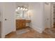 Well-lit bathroom boasts tile flooring, a wooden vanity, and an expansive mirror with sconce lighting at 6029 Shadburn Ferry Rd, Buford, GA 30518