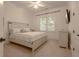 Bedroom featuring a white bed with decorative pillows, a TV, and a window with blinds for privacy at 6029 Shadburn Ferry Rd, Buford, GA 30518