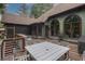 Inviting deck with outdoor dining, views of lush trees, and charming green exterior at 6029 Shadburn Ferry Rd, Buford, GA 30518