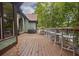 Spacious deck with bar seating, grilling area, and views of the home's exterior at 6029 Shadburn Ferry Rd, Buford, GA 30518